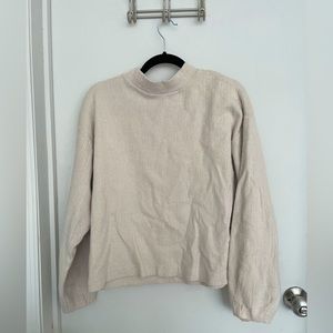 Mock neck cream knit sweater.